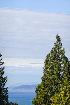 Sea and sky layers with distant shoreline Stock Photos