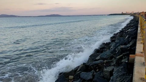 The sea and waves break against the stones in the evening on the embankment Stock Footage 248218904