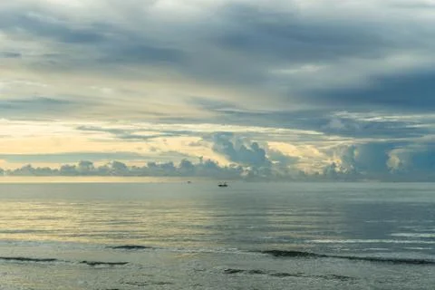 The sea and waves in the morning on a cloudy day. Stock Photos