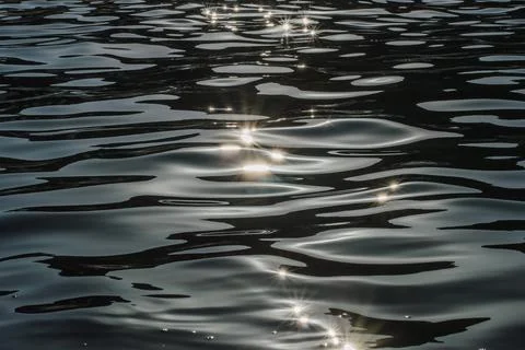 Sea background at sunset ,reflection of sunlight as stars Stock Photos