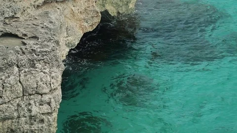 The sea is baked over the surface of the water in the rocks. Spanish beaches in Stock Footage 75606237