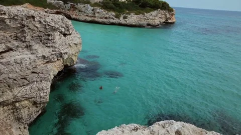 The sea is baked over the surface of the water in the rocks. Spanish beaches in Stock Footage 75612308