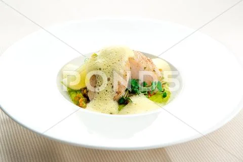 Sea bass fillet infused with sauce foam Stock Photos