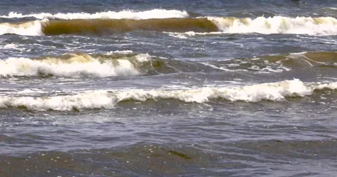 A sea bay with large waves in the rainy evening Stock Footage 340290196