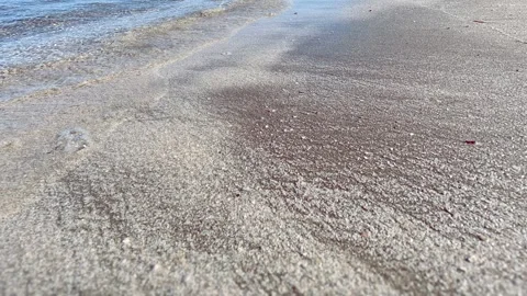 Sea beach closeup slow motion Small ripples on the water, white and yellow sand. Stock Footage 240308524