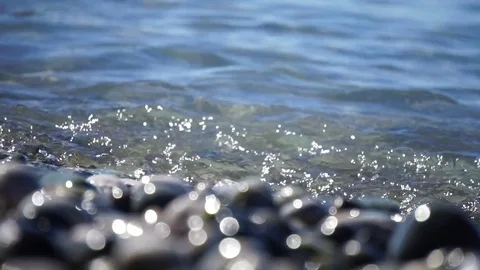 Sea beach of peebles with the foam of the waves in motion Stock Footage 80332139