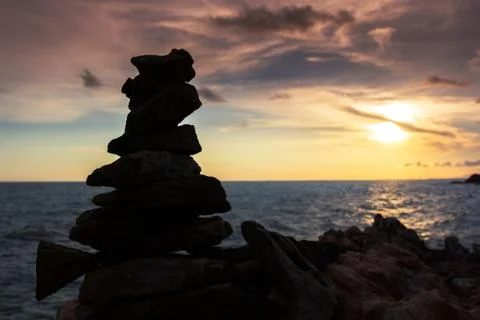 Sea beach stone stack stable and twilight sky background Stock Photos