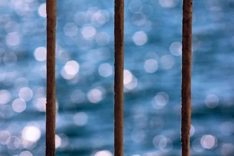 The sea behind the bars Stock Photos