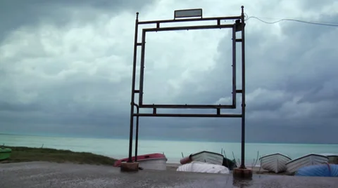 Sea, boat and clouds through an abandoned placard frame Stock Footage 36117199