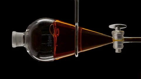 Sea buckthorn extract in vessel causing bubbles to rise inside Stock Footage 340002572