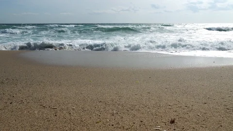 The sea calms down after a storm, but the waves flood the beach Stock Footage 124782855