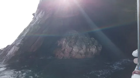 Sea cave interior with dramatic sun rays Ballestas Islands Peru Видео 348781253