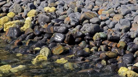 Sea clear waves break on rock. Beautiful of sea water wave come to stone beach. Stock Footage 304575439