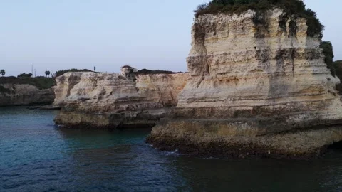 Sea Cliffs and Rock Stacks Along a Quiet Coastline at Dusk. aerial pullback shot Stock Footage 346088674