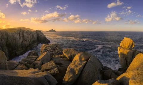 Sea Cliffs Gilted by the Light of the Setting Sun Stock Photos