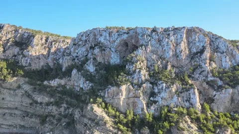 Sea cliffs Ibiza Ses at Balandres clear blue water green trees Stock Footage 164154341