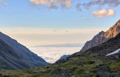 Sea of clouds below mountains Stock Photos