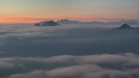 Sea of Clouds with Distant Snow-covered Peaks at Dawn Stock Footage 330759463