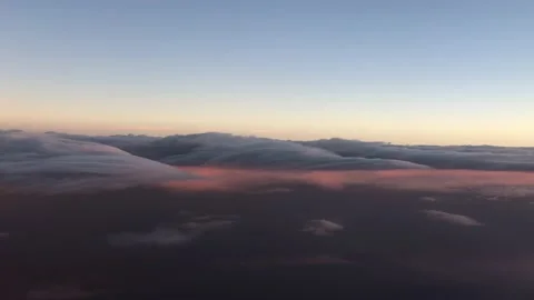 Sea of clouds during sunset flight international intercontinental above Stock Footage 236896110