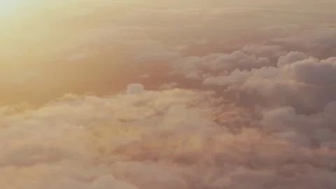 Sea of clouds glowing at sunset from a plane Stock-Footage 347983272