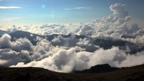 Sea of clouds rises above New Zealand mountain peaks amid humid air and green Stock Footage 339373216