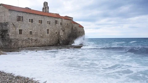 Sea at cloudy weather big waves beating at stone wall Stock Footage 121680847