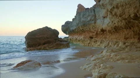 Sea crashes over rocks in a secluded cove Stock Footage 269687740