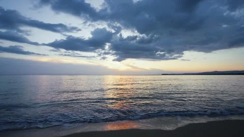 Sea dawn background, view from the beach. Sea waves crash on a sandy beach. Stock Footage 244379108