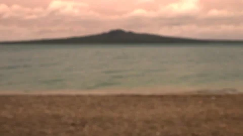 Sea, evening sky with clouds and a mountain in the distance in summer Stock Footage 131881497
