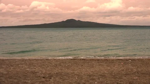 Sea, evening sky with clouds and a mountain in the distance in summer Stock Footage 131881545