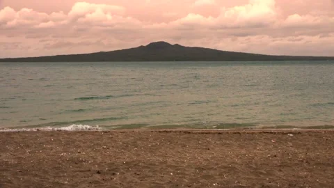 Sea, evening sky with clouds and a mountain in the distance in summer Stock Footage 131881587
