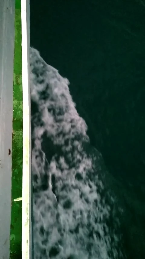Sea Foam and Wake from Ferry Hull Moving Through Ocean Vertical Stock Footage 299701751