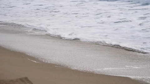 Sea foam on brown sand beach Stock Footage 112121853