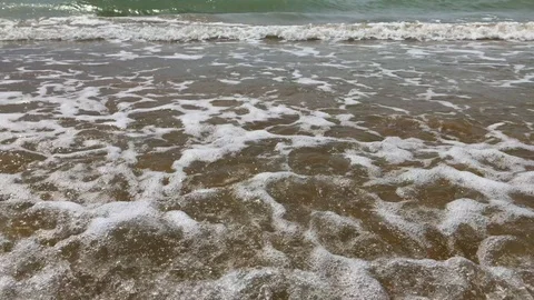 Sea foam in waves on beach, sunlight on sea water Stock Footage 93250383