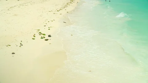 Sea foamy waves rolling on clean white sand beach Stock Footage 105417536