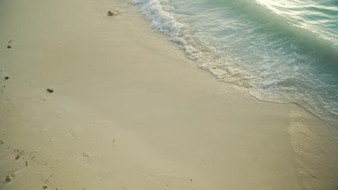 Sea foamy waves rolling on clean white sand beach Stock Footage 105417988