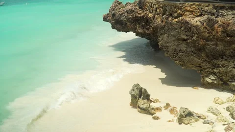 Sea foamy waves rolling on white sand coral rock Stock Footage 105417423
