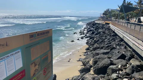 Sea front and black boulders of Roches Noire in Saint-Gilles les Bains Stock Footage 144012653