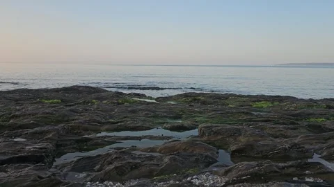 The sea gently lapping against some rocks Video stock 244384795