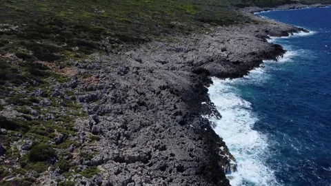 Sea gull passing in front of drone camera above wild waves Stock Footage 266824033