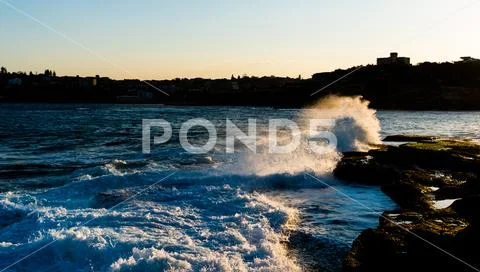 Sea hitting rocks Stock Photos
