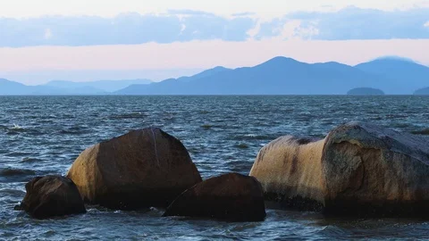 Sea hitting the rocks at sunset, Florianópolis, Santa Catarina, Brazil Stock Footage 129325316