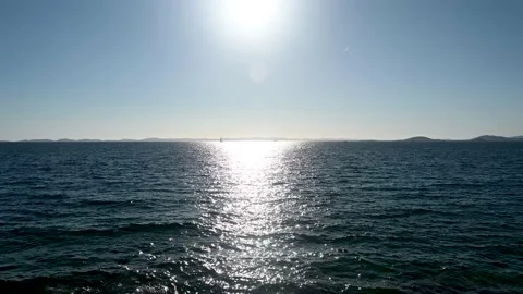 Sea horizon at sunset. Sun reflection on water surface. Deep blue sea. Stock Footage