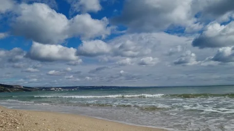 Sea horizon with waves and clouds under bright blue sky Stock Footage 319252401