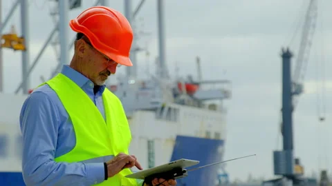 Sea industry port ship taskmaster in helmet checks drawings Stock Footage 166173971