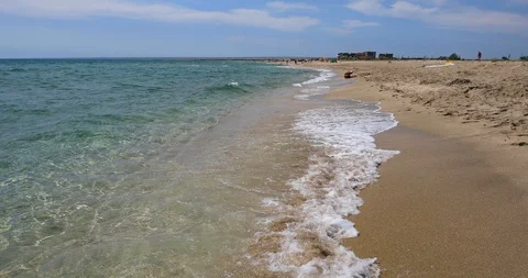 Sea landscape with a dramatic sky and silhouettes of people in the distance. Stock Footage 114628784