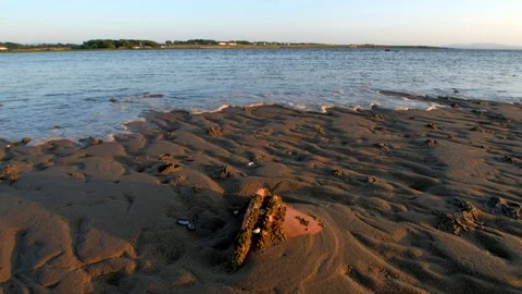 Sea level quickly moving in as the tide rising in a flat sandy beach. Stock Footage