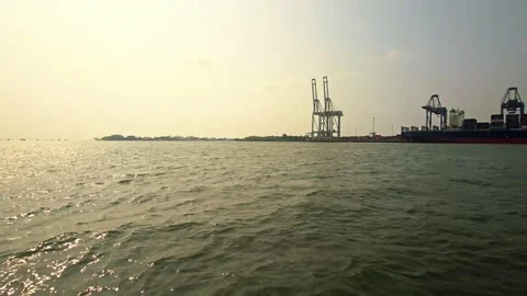 Sea Level View of Golden Sun Reflection Rippling on Choppy Ocean Water Passing a 스톡 동영상 343638678