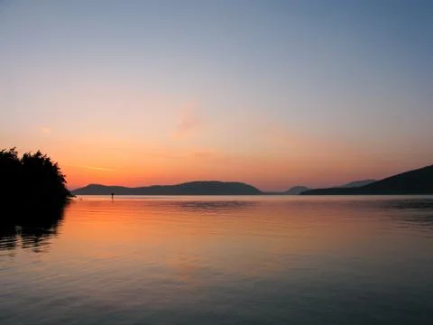 Sea, mountains, sunset Stock Photos