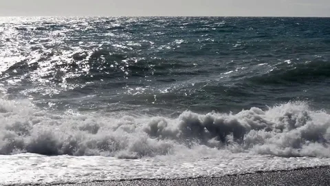 The sea moved by the strong wind crashes with strong waves on the beach Stock Footage 84024018